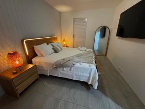 a bedroom with a bed and a lamp and a television at Cairns Waterfront Luxury at Harbourlights in Cairns +34 photos