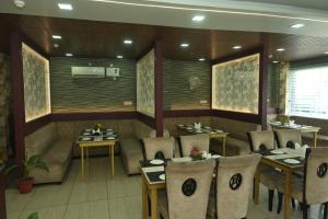 a restaurant with tables and chairs in a room at Hotel Elite Suites in Padrauna