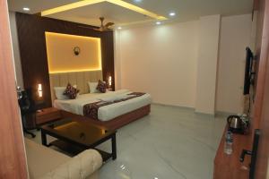 a hotel room with a bed and a couch at Hotel Elite Suites in Padrauna +17 photos