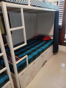 a bunk bed with a ladder in a room at Social Stay Hostal in Ahangama +3 photos