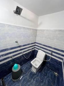 a bathroom with a toilet in a room at Dharitry Homestay Majuli in Mājuli Island