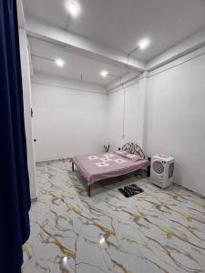 a room with a bed and a tv on the floor at Dharitry Homestay Majuli in Mājuli Island