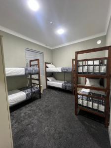 a room with three bunk beds in it at Hostel Mevazor in Katartal