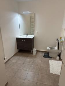 a bathroom with a toilet and a sink and a mirror at Bright and cozy studio entre Paris et Disneyland in Champs-sur-Marne +4 photos