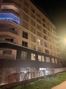 an apartment building at night with the lights on at Bright and cozy studio entre Paris et Disneyland in Champs-sur-Marne