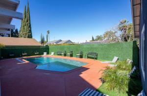 a swimming pool in a yard with chairs around it at silver in Chatsworth