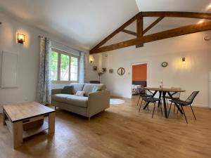 a living room with a couch and a table at Le Cocon de Langes in Orange