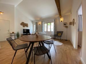 a living room with a table and chairs at Le Cocon de Langes in Orange