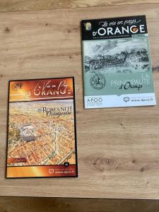 two dvds sitting on top of a wooden table at Le Cocon de Langes in Orange