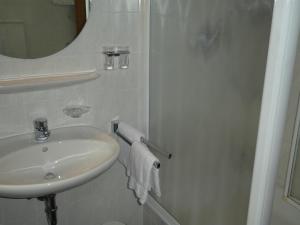 a white bathroom with a sink and a shower at Gästehaus Bergblick in Wallgau +16 photos