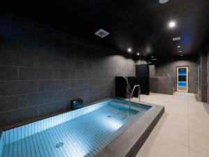 a swimming pool in a room with a brick wall at Minn Gion Sanjo in Kyoto +15 photos