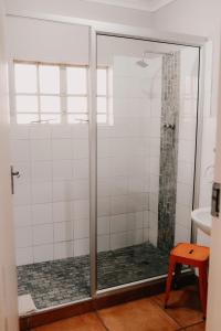 a shower with a glass door in a bathroom at La Rona Hospitality Services in Rustenburg +40 photos