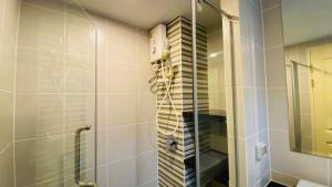 a shower with a glass door in a bathroom at Vista Residence Old Town in Phuket +26 photos
