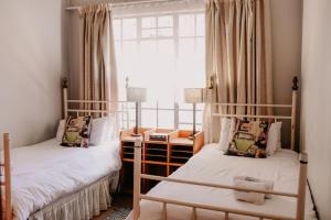 two bunk beds in a room with a window at La Rona Hospitality Services in Rustenburg