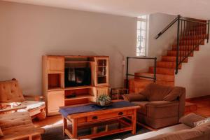 a living room with a couch and a tv at La Rona Hospitality Services in Rustenburg