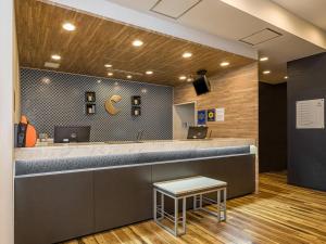 a reception counter in a dental office with a table at Comfort Hotel Tokyo Kanda in Tokyo