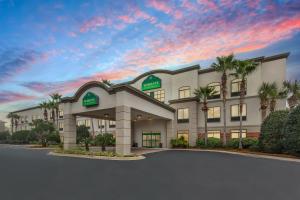a rendering of a hotel with palm trees at Wingate by Wyndham Destin in Destin