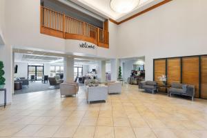 a lobby of a hospital with couches and chairs at Wingate by Wyndham Destin in Destin +41 photos