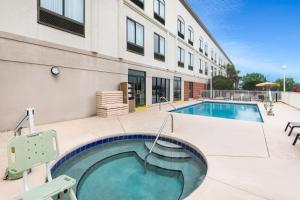 a swimming pool in front of a building at Wingate by Wyndham Destin in Destin