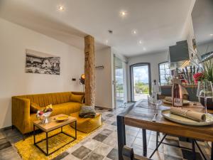 a living room with a yellow couch and a table at Country Lodge - Heuboden in Tating