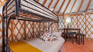 a bed in a room with a loft bed at Yurt 1 - The Prospector in Idaho City