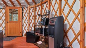 a living room with a tv and a door at Yurt 1 - The Prospector in Idaho City
