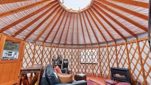 a room with a yurt with a couch and a fireplace at Yurt 1 - The Prospector in Idaho City