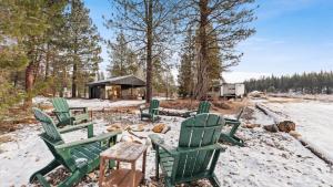 a group of green lawn chairs in the snow at Yurt 1 - The Prospector in Idaho City +5 photos