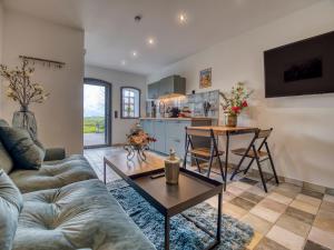 a living room with a couch and a table at Country Lodge - Stall in Tating