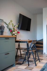 a desk with a flat screen tv on a wall at Country Lodge - Stall in Tating