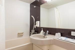 a bathroom with a sink and a mirror at Comfort Hotel Niigata in Niigata