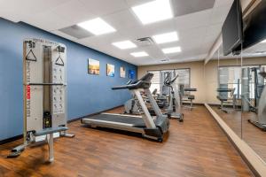 a gym with several tread machines in a room at Comfort Suites Elizabethtown in Elizabethtown