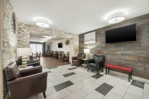 a waiting room with chairs and a flat screen tv at Quality Inn Concord Kannapolis in Concord