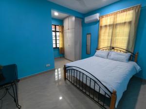 a blue bedroom with a bed and a window at Together Hideaway Cheras 22pax 5R4B KTV, BBQ, ARCADE GAMES CHINESE, MALAY ONLY in Cheras