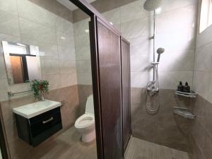 a bathroom with a shower and a toilet and a sink at Together Hideaway Cheras 22pax 5R4B KTV, BBQ, ARCADE GAMES CHINESE, MALAY ONLY in Cheras +35 photos