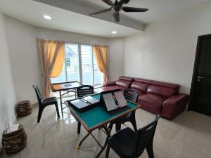 a living room with a couch and a table and chairs at Together Hideaway Cheras 22pax 5R4B KTV, BBQ, ARCADE GAMES CHINESE, MALAY ONLY in Cheras