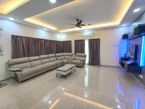 a living room with a couch and a tv at Together Hideaway Cheras 22pax 5R4B KTV, BBQ, ARCADE GAMES CHINESE, MALAY ONLY in Cheras