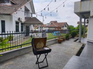 a chair sitting on a porch with a fence at Together Hideaway Cheras 22pax 5R4B KTV, BBQ, ARCADE GAMES CHINESE, MALAY ONLY in Cheras