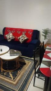 a living room with a blue couch and a table at Primestay Suites in Eldoret