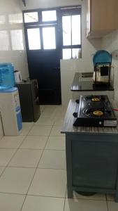 a kitchen with a stove and a black door at Primestay Suites in Eldoret +18 photos