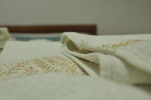 a white bed with white sheets and pillows at Hotel Limni in Agios Panteleimon