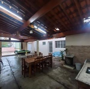 a large room with a table and chairs and a fireplace at Edicula Paz e Amor in Piracicaba