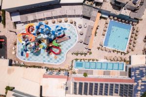 an overhead view of a swimming pool and a resort at SunBay Hotel in Hersonissos