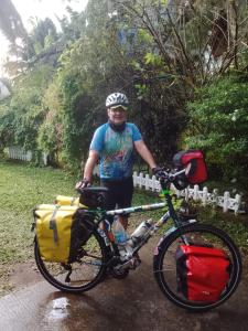 a man standing next to a bike in the rain at Nobel Bibila Hotel in Bibile