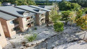 an aerial view of a building with a yard at Livemax Resort Yatsugatake Kogen in Hokuto