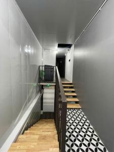 a hallway with a staircase with black and white tiles at Hotel Hc Luxury Apartment in Hanoi