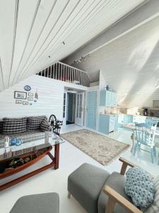 a living room with a couch and a table at Cabin by the lake in Sveio