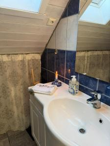 a bathroom with a sink and a mirror at Cabin by the lake in Sveio +9 photos