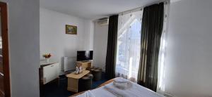 a hotel room with a bed and a window at Vila Casa Alesiv in Cluj-Napoca