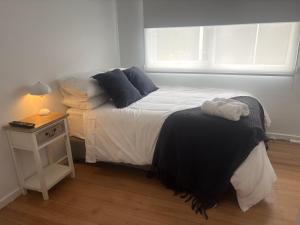 a small bedroom with a bed and a night stand at Willow Place in Mornington